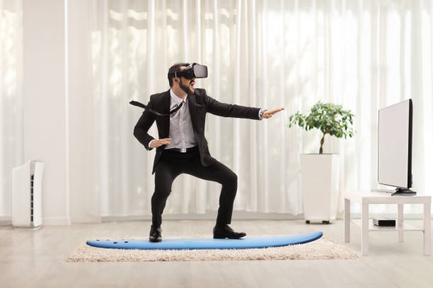Businessman riding a surfboard with a VR headset