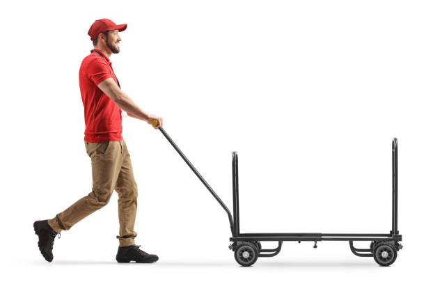 istock Delivery worker pushing an empty hand truck 1317498111