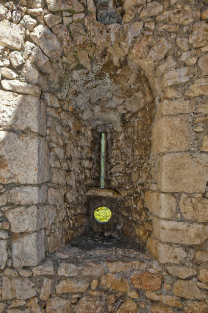 The old town of Sermoneta, Italy. Sermoneta, Italy, 05/10/2021. An opening in the wall of an medieval castle in a medieval town in the Lazio region. village lazio photography sermoneta stock pictures, royalty-free photos & images