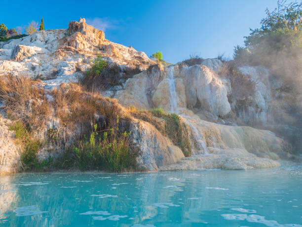 geothermal pool and hot spring in tuscany, italy. bagno vignoni free thermal waterfall in the morning with no people. - vignoni imagens e fotografias de stock