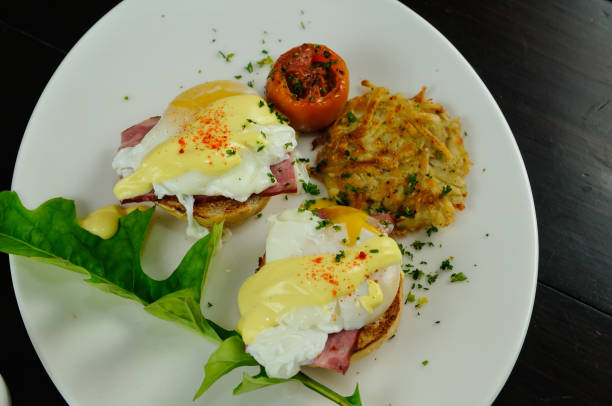 istock Eggs Benedict, Poached eggs with vegetables, sausage, and tomato. Pakora and beef with the eggs. 1317501584