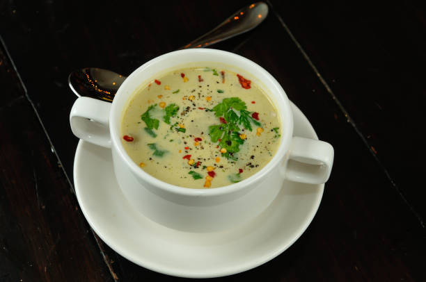 istock Mushroom soup in a bowl. White plate served on a black table counter. 1317502487