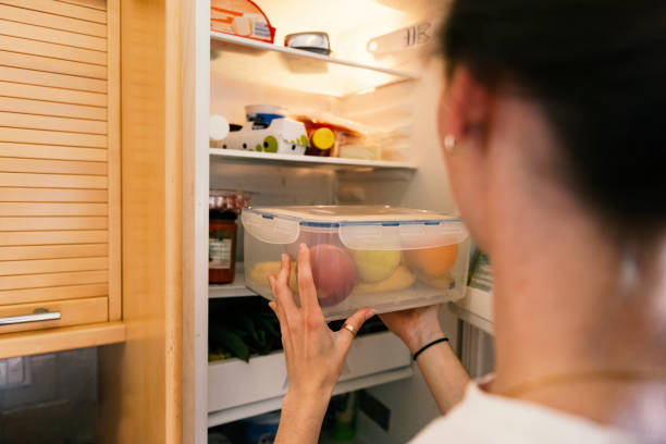 istock Young woman taking raw food from refrigerator 1317502495