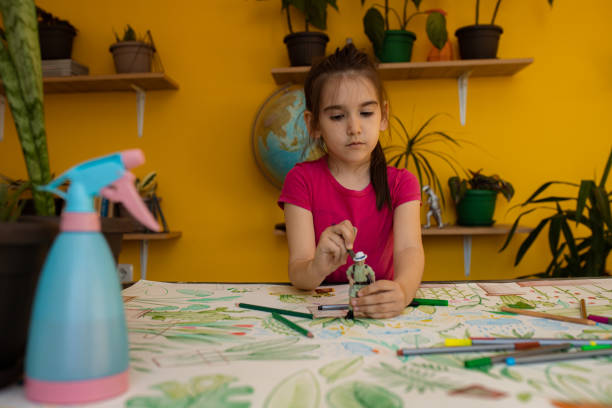 istock Girl drawing plants at home 1317502519