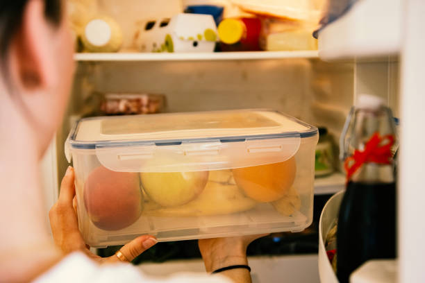 istock Young woman taking raw food from refrigerator 1317502532