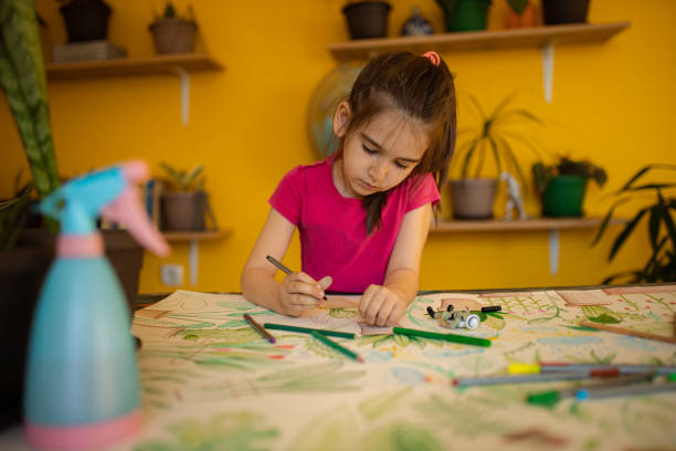 istock Girl drawing plants 1317502549