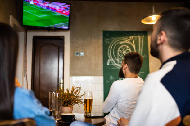 istock Friends watching a soccer game 1317503094