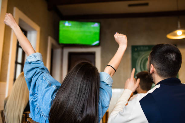 istock Young adults rooting for their favorite soccer team 1317503642