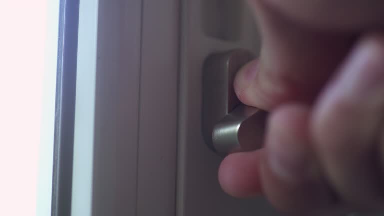 Close up hands Locking and unlocking the front door from inside at home