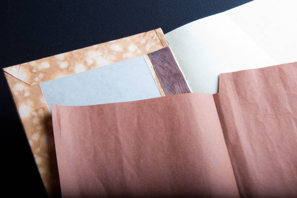 istock The process of book binding; adding the brown endsheets 1317503839