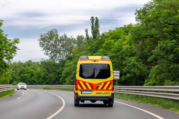 Ambulance van on the road. Bright green trees along road Ambulance van on the road. Bright green trees along road bus hungary stock pictures, royalty-free photos & images