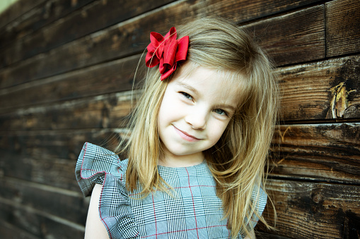 Portrait of pretty little girl in a dress, outdoors