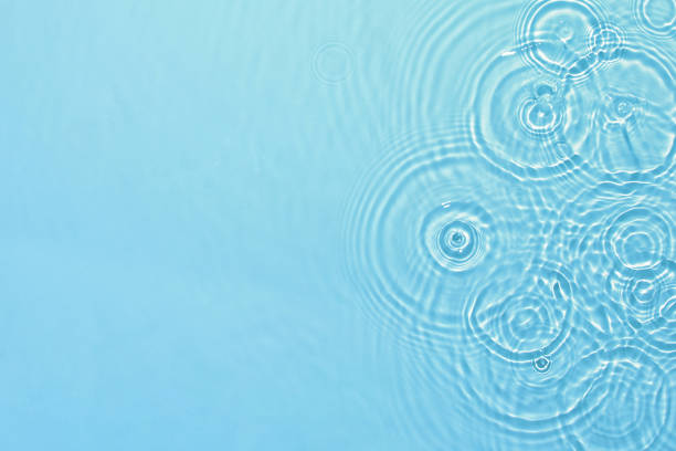 transparent blue colored clear calm water surface texture - ripple water waterdrop drop imagens e fotografias de stock