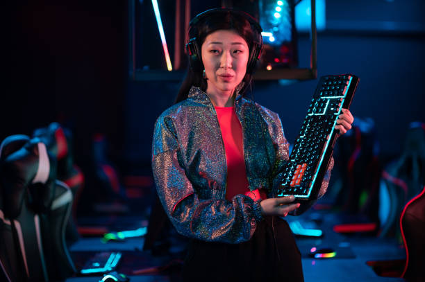 istock An experienced asian gamer shows a gaming keyboard and talks about its advantages 1317507828