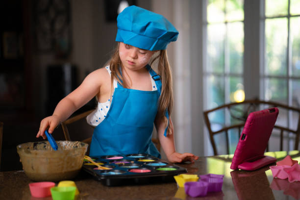 istock Little girl prepping the cupcakes dough 1317507914