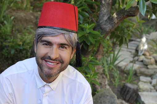 Mature middle Eastern man wearing classic fez hat.