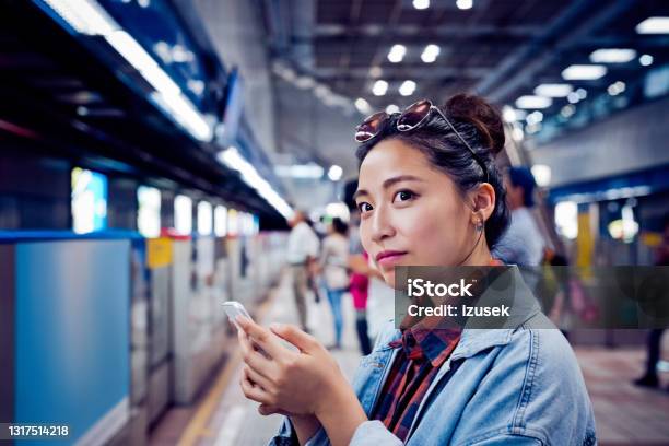 Woman With Mobile Phone At Subway Station Stock Photo - Download Image Now - 20-24 Years, Adult, Adults Only