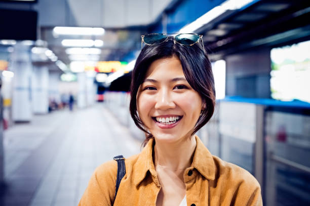 istock Smiling young woman at subway station 1317514701