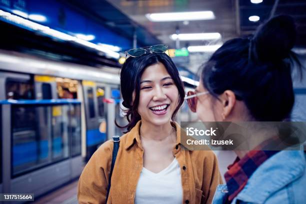 Happy Young Female Friends At Subway Station Stock Photo - Download Image Now - 20-24 Years, Adult, Adults Only