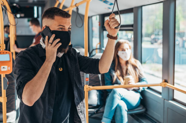 istock Young handsome man wearing protective mask and using his smartphone 1317515905