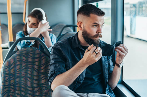 istock Young handsome man putting protective mask in a bus 1317515940