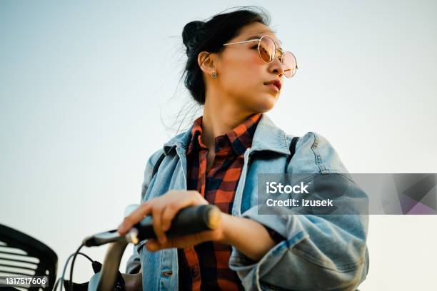 Woman With Bicycle Looking Away Stock Photo - Download Image Now - 20-24 Years, Adult, Adults Only