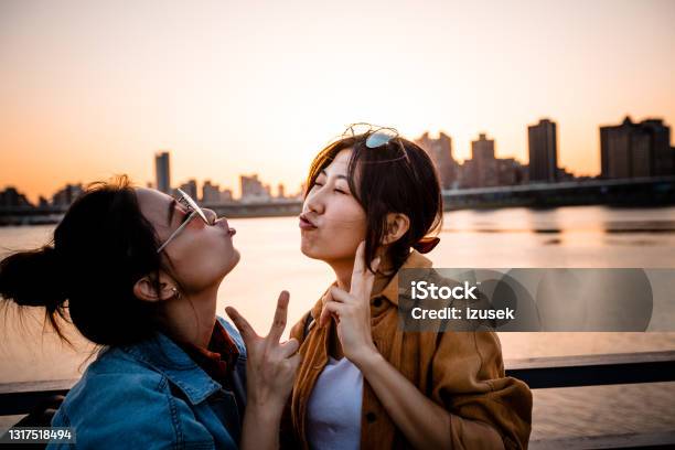 Happy Female Friends Enjoying Weekend In City Stock Photo - Download Image Now - 20-24 Years, Adult, Adults Only