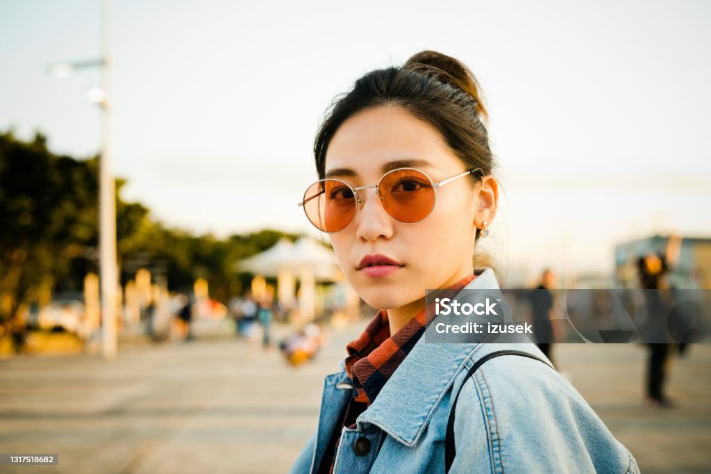 Beautiful woman on city break during weekend Portrait of young woman on street. Beautiful female is in city during weekend. She is wearing casuals. 20-24 Years Stock Photo