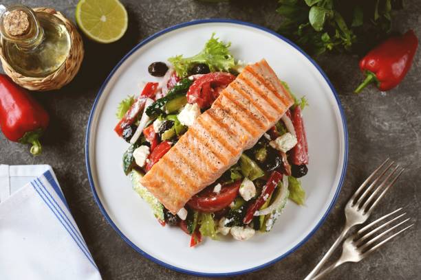 Greek salad with grilled salmon. Healthly food. stock photo