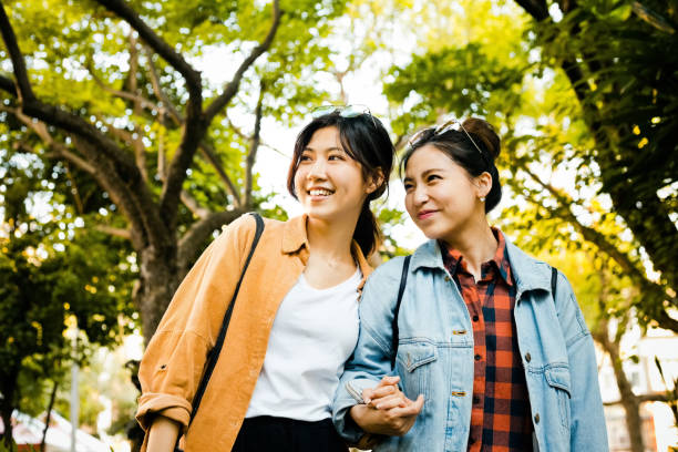 istock Young female friends in park during weekend 1317518816
