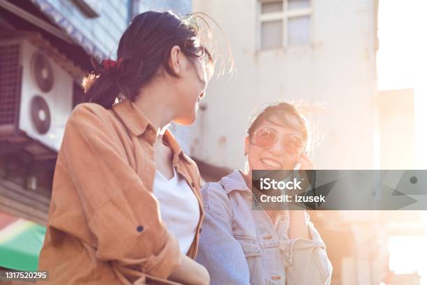 Female Friends Enjoying Weekend In City Stock Photo - Download Image Now - 20-24 Years, Adult, Adults Only
