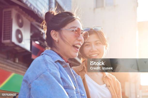 Cheerful Female Friends Enjoying City Break Stock Photo - Download Image Now - 20-24 Years, Adult, Adults Only