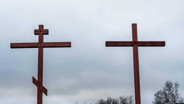 istock Orthodox and Catholic crosses side by side on dramatic sky background. The concept of unity of faith. Space for text. 1317521463