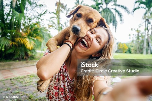 istock Young Woman Takes Selfie With Her Dog 1317523051
