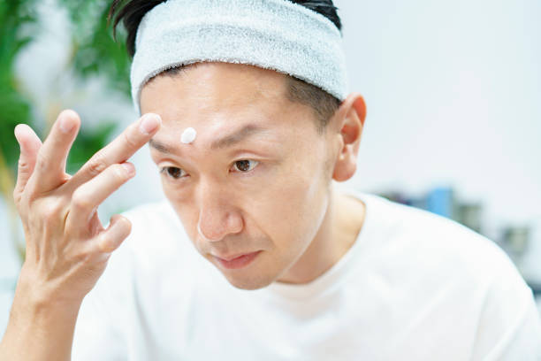 istock Men applying moisturizing cream to their face 1317528277