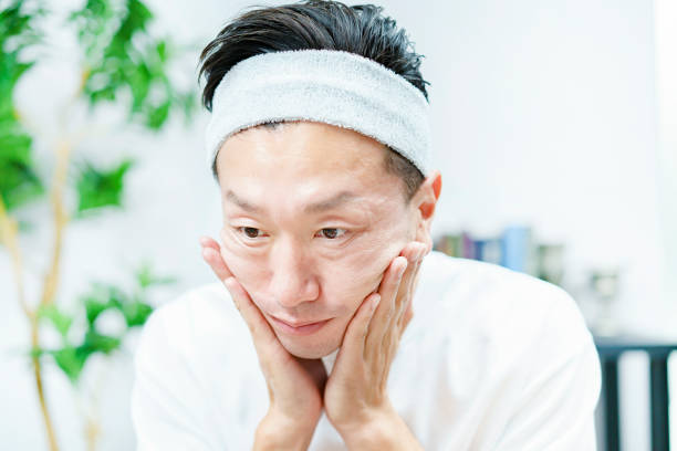 istock Men applying moisturizing cream to their face 1317528336