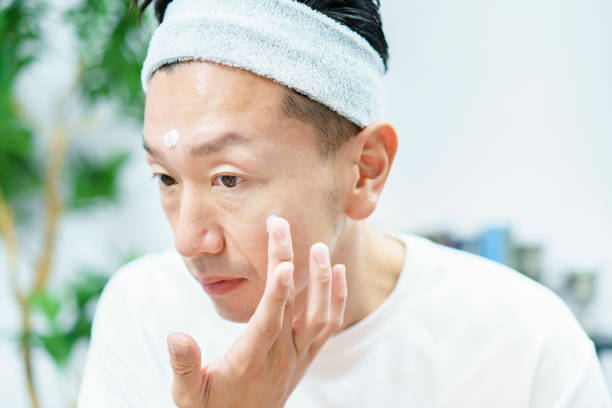 istock Men applying moisturizing cream to their face 1317528370