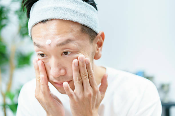 istock Men applying moisturizing cream to their face 1317528381
