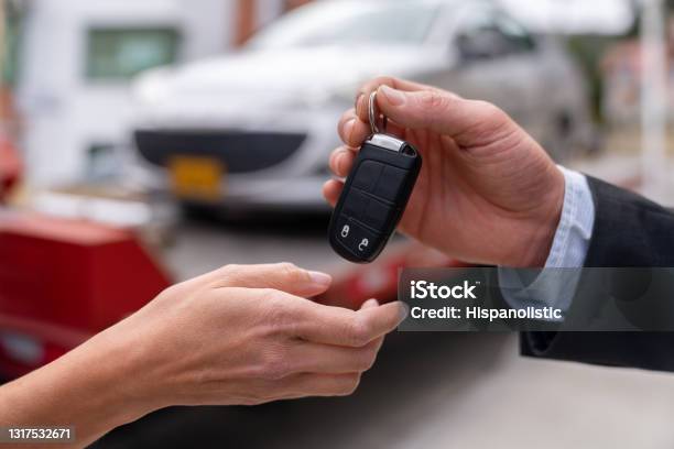 Closeup On A Salesman Delivering A Car While Handling The Keys Stock Photo - Download Image Now
