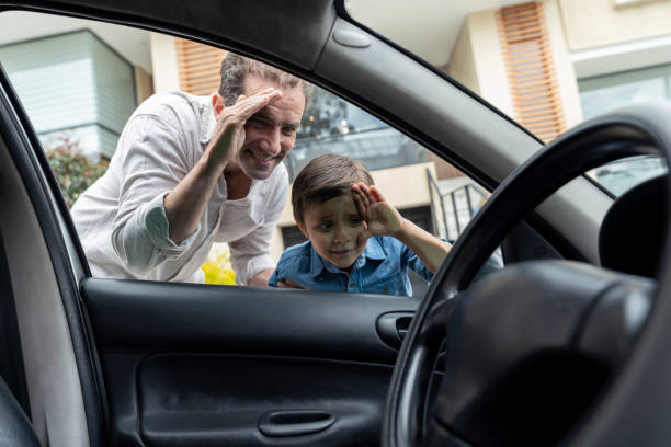 istock Father and son looking into a car through the window 1317532754