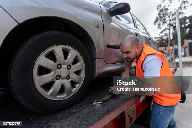 Latin American Tow Truck Operator Towing A Car Stock Photo - Download Image Now - Tow Truck, Car Transporter, Car
