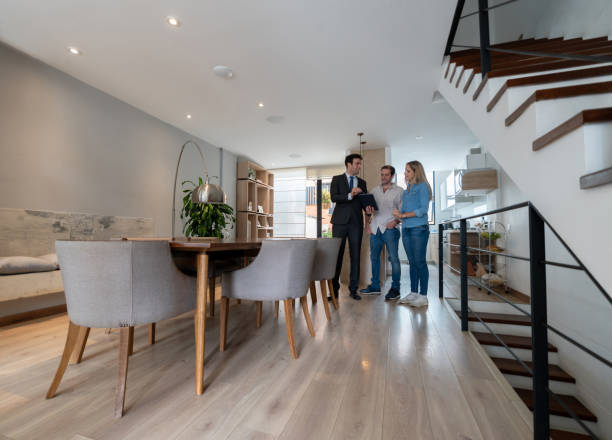Real Estate Agent showing a house to couple interested in buying a property Real Estate Agent showing a house to a Latin American couple interested in buying a property - home ownership concepts real estate agent male stock pictures, royalty-free photos & images
