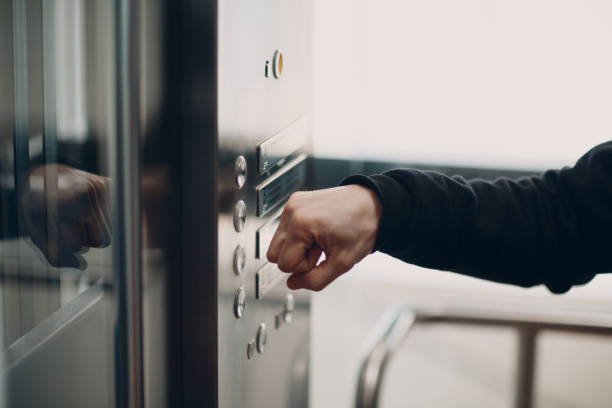 istock Close up of forefinger pressing the button elevator during coronavirus pandemic covid-19 quarantine concept 1317534254