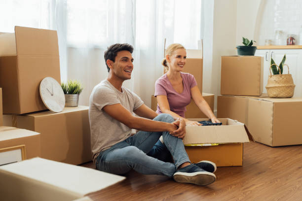 istock Couple packing stuffs in cardboard box 1317534490