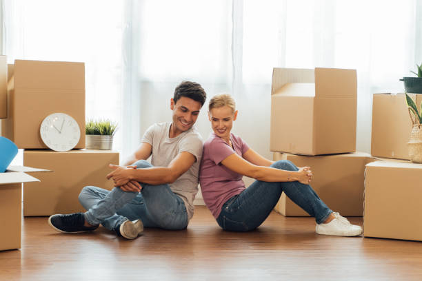 istock Couple packing stuffs in cardboard box 1317534491