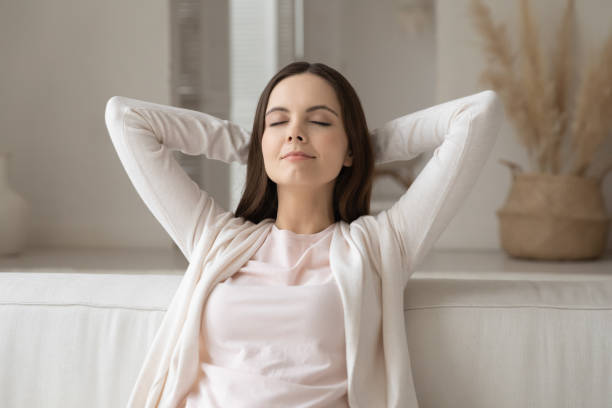 istock Peaceful girl with closed eyes resting on comfortable couch 1317535573