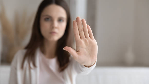 istock Serious young millennial woman making hand stop gesture at home 1317535582