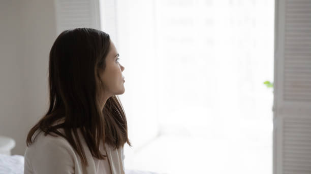 istock Thoughtful millennial young woman looking away at window 1317535611