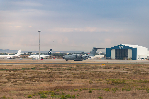 Paphos Airport in Cyprus. Planes on the runway and at the hangars. Military aircraft at the airport.
