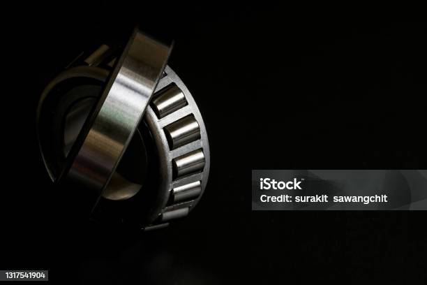 Closeup Of Tapered Roller Bearing On Black Background Spare Part Of Mechanical Industry Stock Photo - Download Image Now